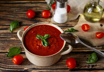 fresh tomato soup in a bowl. on a wooden table. food