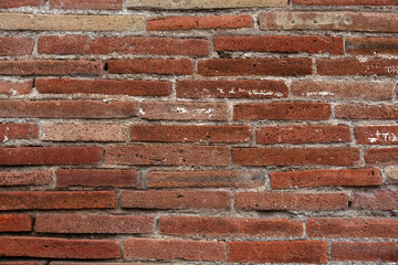 Old brick wall. Ancient Roman masonry made of thin bricks - plinths.