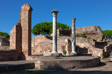 Columns remaining from ancient structures. Archaeological sites in Italy.