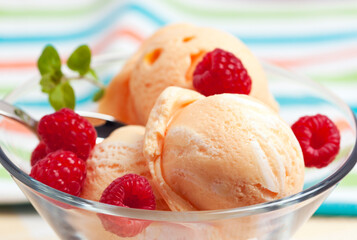 Peach Ice Cream or Sorbet with Raspberries in Glass Bowl