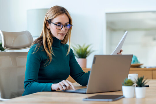 Beautiful businesswoman working on laptop in office