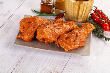 Raw turkey shoulder wing in Indian tandoori marinade