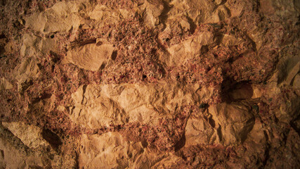 Wall made of marble pieces and mixture of crushed ceramics and marble sand,  orange pastel colors, beautiful background, indestructible walls, construction production and technology, close-up