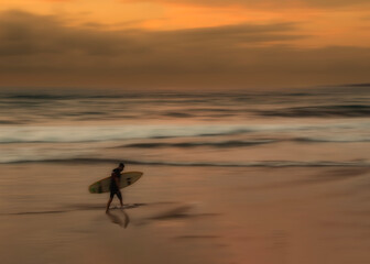 fine art photography surfer coming out of the water at sunset © Miguel Diaz Ojeda