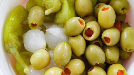 Stuffed green olives, marinated pearl onions, marinated hot green peppers, typical Italian appetizers, vegetable appetizers, marinated vegetables, green vegetables, vegan aperitif, Italy