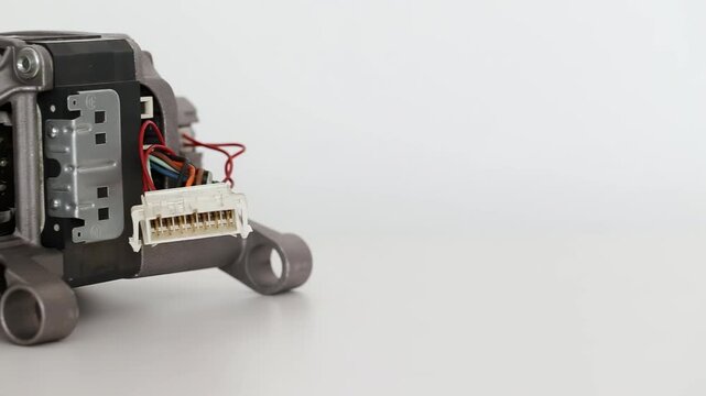Asynchronous electric motor from a washing machine on a white background, close-up, isolate.