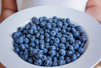 Fresh raw organic blueberries background close up. Macro texture of blueberry berries. Food background, backdrop, wallpaper, summer harvest.