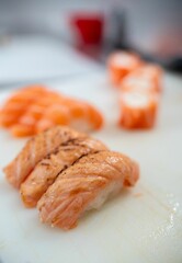 Fresh salmon sushi close-up on cutting board.