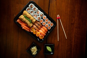 Sushi assortment with chopsticks and soy sauce.