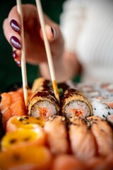 Close-up of sushi with chopsticks.