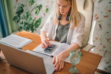 Creating a Calm and Focused Home Office Environment, a woman with a laptop at a table
