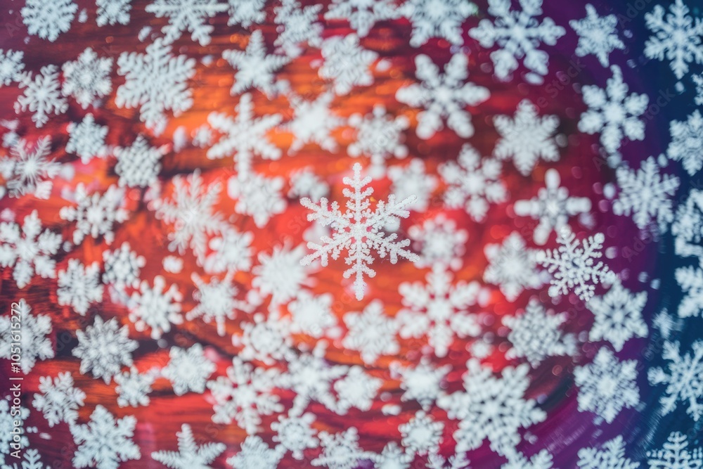 Poster Close up single snowflake on red purple background with others out of focus.