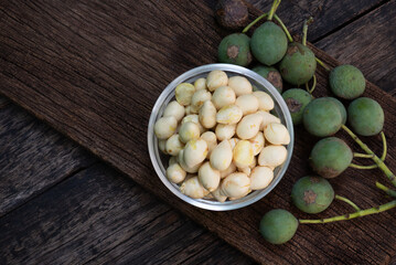 Alexandrian laurel or Calophyllum inophyllum fruits on an old wooden  background.top view.