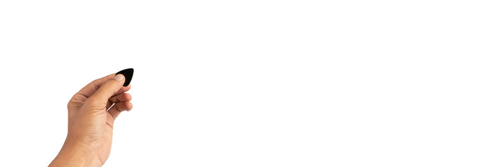 Black male hand holding a guitar pick isolated on white background banner