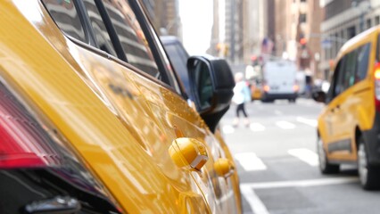 New York City. Yellow taxi car on Manhattan street. Taxi cab on Midtown Lexington avenue. Medallion taxicab rear view on Lex ave waiting for people or passengers on road. Urban scene in United States.