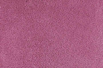 Pink suede leather texture with embossed shabby spotted pattern. Structure of fleecy cloth surface, decorative upholstery fabric, home decor and garment. Wallpaper, background, backdrop.