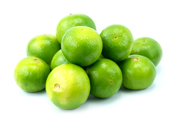 Heap of fresh lime fruits isolated on white background close up stacking