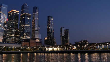 Obraz premium New York City skyline from river ferry boat. Manhattan Midtown, Hudson Yards skyscrapers from ferryboat. Waterfront panorama, riverfront buildings architecture, USA. Evening dusk, night twilight.