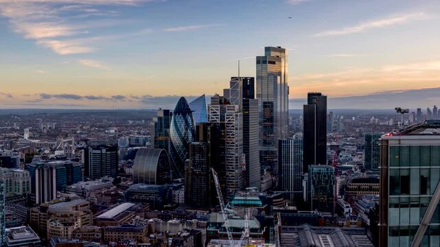 Day to night time lapse view of the City of London with the financial skyscrapers and Tower Bridge in the background