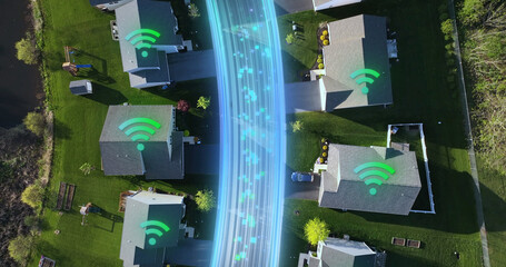 Suburban homes with Wi-Fi symbols projected on rooftops and digital fiber optics stream between houses. Technology concept. Aerial