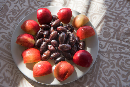 Fruit plate of dates and apple served aboard the Dahabeah, passenger river boat of the Lazuli fleet, sailing on the Nile river, Egypt, North Africa, Africa