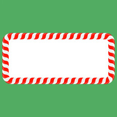Fototapeta premium Vector Christmas candy cane frame with red and white stripes on green background. Xmas border.