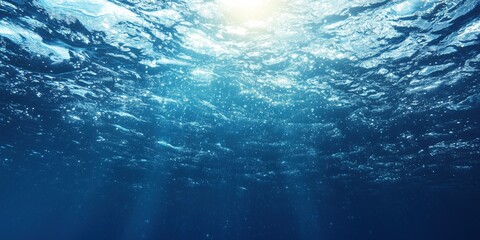 Underwater scene with sunlight, shimmering water surface, and bubbles