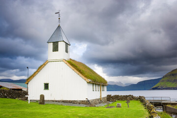 Oyndarfjarðar church against dark stormy sky, Faroe Islands