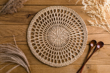 round woven straw napkin on wooden background