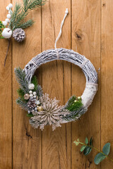 Christmas wreath on wooden background, banner, copyspace