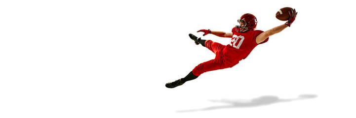 Focused man, American football player in red uniform in motion, catching the ball in mid-air, training isolated on white background. Concept of sport, competition, tournament, game. Copy space