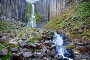 Stuðlafoss waterfall surrounded by basalt rock columns, Iceland