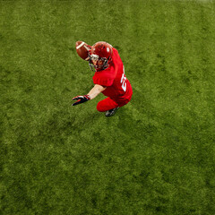 Competitive and determined athlete, American football player in motion on field, competing, throwing ball, playing. Concept of sport, competition, tournament, game. Copy space
