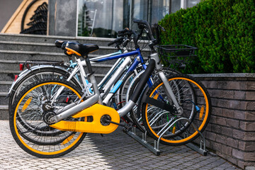 Bicycles parked in urban setting near modern building