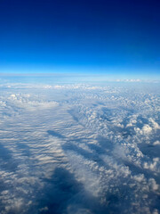 Aerial view above blue sky clouds during daytime