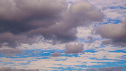 Dramatic sky with autumn puffy clouds background