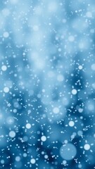 Fototapeta premium Abstract winter background with falling snowflakes and a soft blue glow