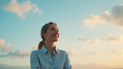 Confident and Happy Business Woman Standing Against a Beautiful Sky Background – Embracing Success, Ambition, and Optimism