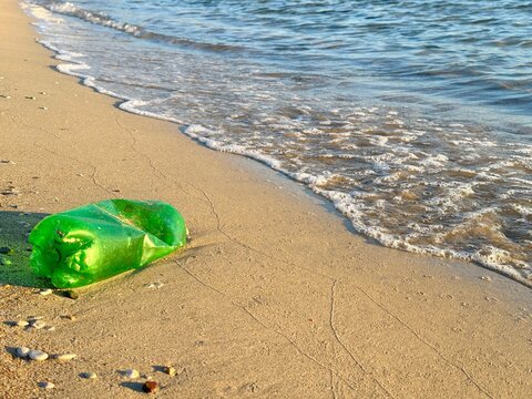 Close-up of a discarded Green plastic bottle washed up on a beach, Skala, Agistri, Saronic Islands, Greece