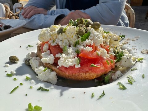 Close-up of a man sitting in an outdoor cafe with a cretan salad, Greece