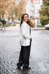 Stylish Woman with Long Hair in Urban Street Setting