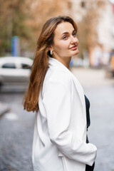 Fototapeta premium Elegant Portrait of a Woman in a City Setting