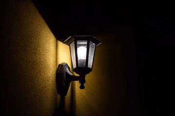 A minimal style shot of a lantern shining in the dark