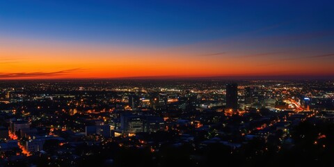 Fototapeta premium City skyline at dusk with vibrant sunset colors and city lights