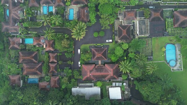 Aerial View of a Villa with a swimming pool on a Plateau Surrounded by trees