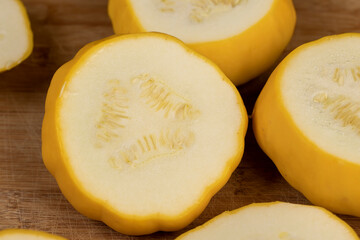 cut yellow ripe pumpkins on the table in close-up