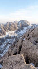 Fototapeta premium A climber ascends a frozen wall, showcasing determination and skill against a stunning mountain backdrop