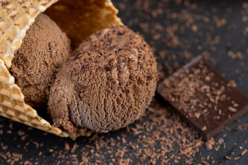 chocolate ice cream with chocolate chips on black slate