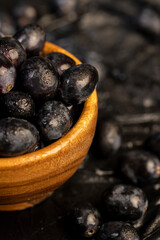 fresh grapes are lying on black paper