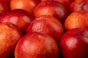 a large number of ripe soft nectarine fruits on the table